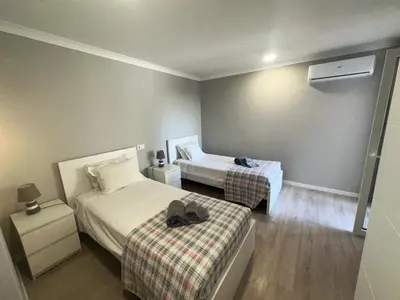 a hotel room with two beds and a hat on a bed at Cliff Enchantment - Pool and Sea View in Albufeira in Albufeira