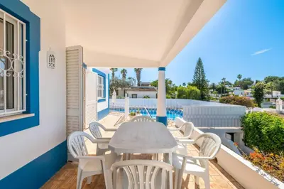 a table and chairs on the balcony of a house at Villa Gabriella - Charming villa in great location close to everything you need in Guia
