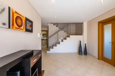 a hallway with a staircase in a house at Villa Hugo - bright modern walk to restaurants in Albufeira