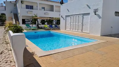 a swimming pool in front of a building at Villa Gabriel by Sunny Deluxe in Albufeira