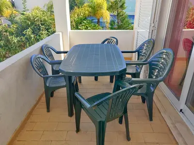 a blue table and chairs on a balcony at Villa Gabriel by Sunny Deluxe in Albufeira