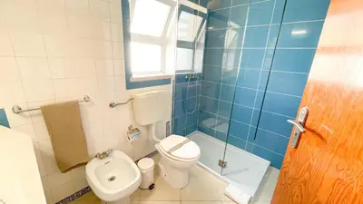 a bathroom with a toilet and a tub and a sink at Villa Gabriel by Sunny Deluxe in Albufeira