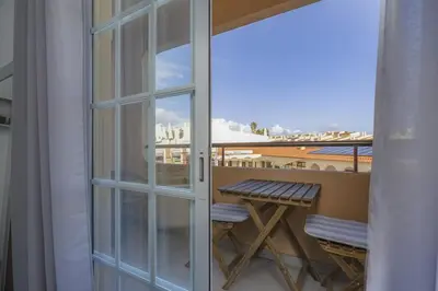 a sliding glass door with a table on a balcony at BELLAVISTA STUDIO - Modern and Renovated near Fishermen's Beach in Albufeira