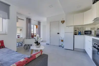 a kitchen and living room with a bed and a table at BELLAVISTA STUDIO - Modern and Renovated near Fishermen's Beach in Albufeira