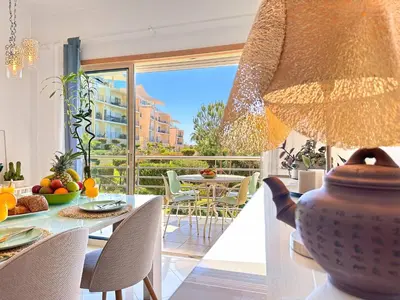 a room with a table with a vase and a balcony at Azure Heaven by BeCherish in Páteo