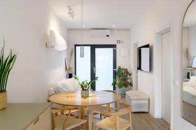 a kitchen and living room with a table and chairs at Beach front right on the Sand Luxury semi-detached 3 bed Villa in Faro