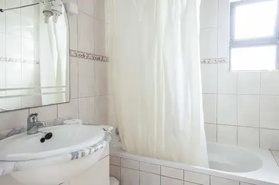 a bathroom with a sink and a shower curtain at Villa Cesaltina in Guia