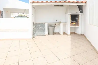 an open garage with a tile floor at Villa Cesaltina in Guia