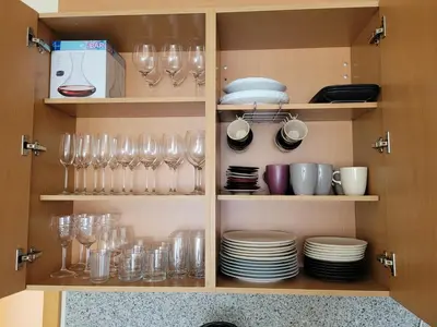a cupboard filled with glasses and plates and dishes at Penthouse Monte da Eira - Sunset in Albufeira