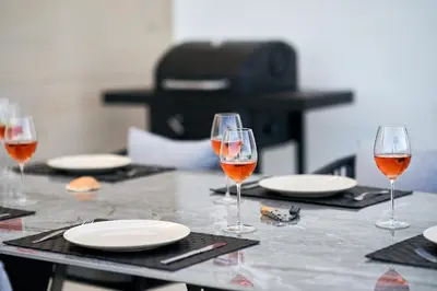 a table with glasses of wine and plates on it at Penthouse Monte da Eira - Sunset in Albufeira
