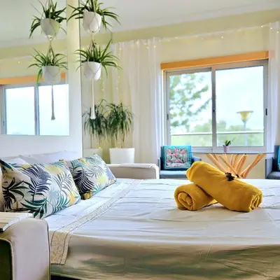 a large bed with a stuffed animal on top of it at T1 Albufeira Tranquilidade in Albufeira