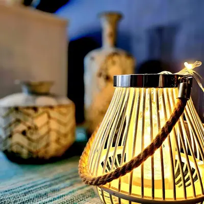 a lamp with a rope on a table with other vases at T1 Albufeira Tranquilidade in Albufeira