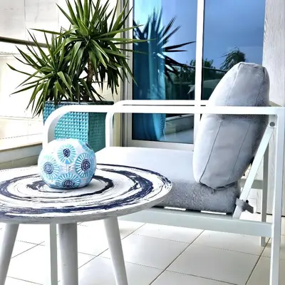 a white chair and a bowl on a table at T1 Albufeira Tranquilidade in Albufeira