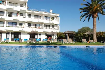 a hotel with a swimming pool in front of a building at Solar dos Vilarinhos - By bedzy in Albufeira
