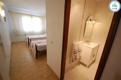 a room with two beds and a sink and a mirror at Solar dos Vilarinhos - By bedzy in Albufeira