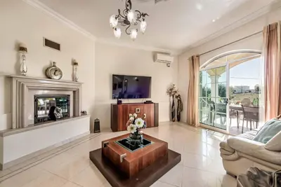 a living room with a fireplace and a tv at Villa Caty Catarina in Albufeira