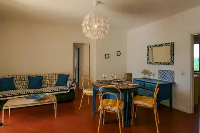a living room with a table and a couch at FLH Olhos D' Água Apartment with Pool in Albufeira