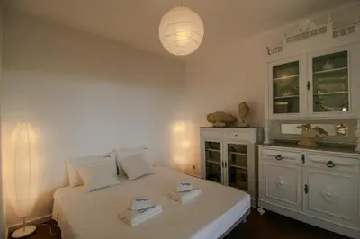 a bedroom with a bed with two boxes on it at FLH Olhos D' Água Apartment with Pool in Albufeira
