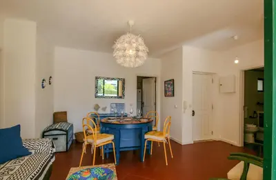 a living room with a blue table and chairs at FLH Olhos D' Água Apartment with Pool in Albufeira