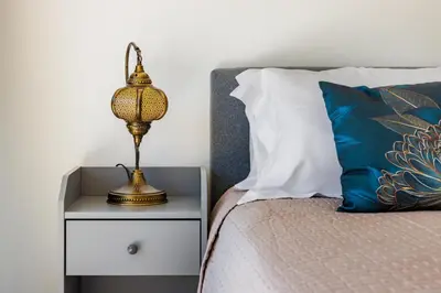 a lamp on a night stand next to a bed at Albufeira - Anna Town - NEW in Albufeira