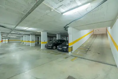 a parking garage with two cars parked in it at Albufeira - Anna Town - NEW in Albufeira
