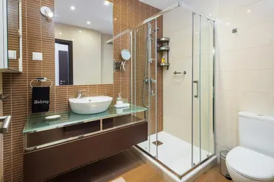 a bathroom with a sink and a glass shower at Albufeira - Anna Town - NEW in Albufeira