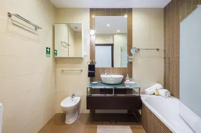 a bathroom with a sink and a tub and a toilet at Albufeira - Anna Town - NEW in Albufeira