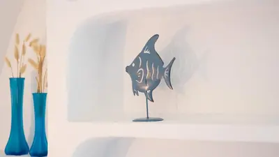 a figurine of a fish on a stand next to two vases at Villa Casa Amendoeiras by LovelyStay in Albufeira