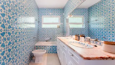a blue bathroom with a sink and a toilet at Villa Casa Amendoeiras by LovelyStay in Albufeira