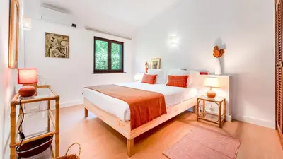 a bedroom with a bed and two lamps in it at Villa Casa Amendoeiras by LovelyStay in Albufeira