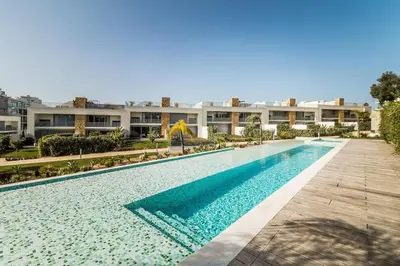 a large swimming pool in front of a building at Family Villa 3 Bedrooms private rooftop with Pool in Albufeira