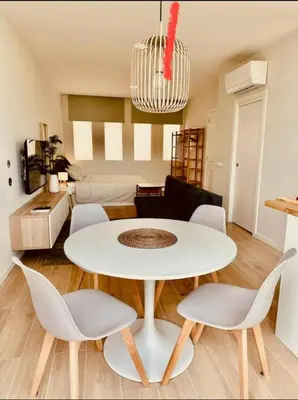 a white table and chairs in a living room at Alagoas Studio - City Center in Faro