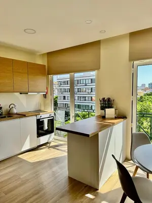 a kitchen with a counter and a large window at Alagoas Studio - City Center in Faro