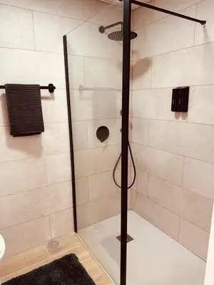 a shower with a glass door in a bathroom at Alagoas Studio - City Center in Faro