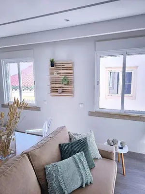 a living room with a couch and two windows at Oldtown Nightlife 2 in Faro