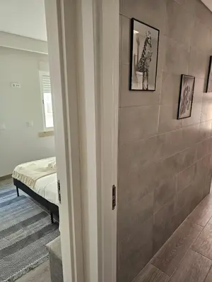a room with a tile wall with a bed at Oldtown Nightlife 2 in Faro