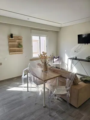 a living room with a table and chairs and a couch at Oldtown Nightlife 2 in Faro