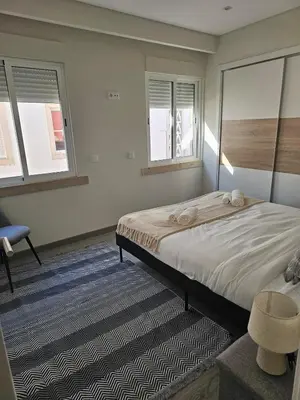 a bedroom with a large bed and two windows at Oldtown Nightlife 2 in Faro