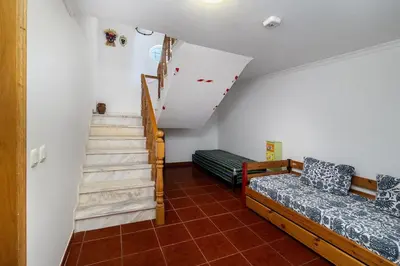a living room with a staircase and a couch at Villa Império in Albufeira