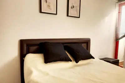 a bedroom with a bed with two pillows on it at Vacation Apartment in Vilamoura in Quarteira
