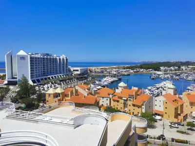 a view of a city with a marina and buildings at MarinaMar Vilamoura Sea View in Quarteira