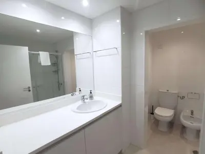 a white bathroom with a sink and a toilet at MarinaMar Vilamoura Sea View in Quarteira