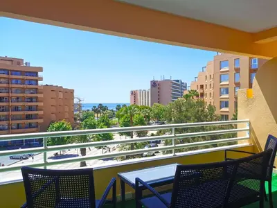 a balcony with a table and chairs and a view of a city at MarinaMar Vilamoura Sea View in Quarteira