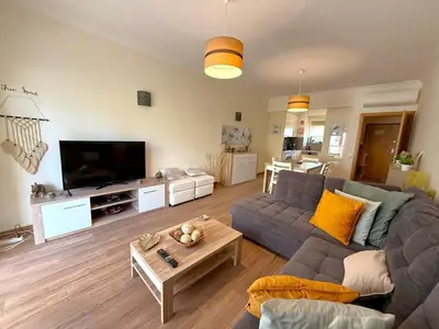 a living room with a couch and a table at Albufeira Marina Gardens AO in Albufeira