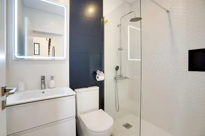 a bathroom with a toilet and a sink and a shower at Quinta do Cerro in Loulé