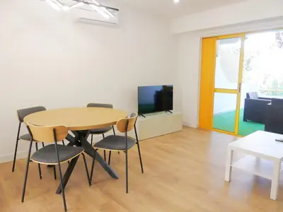 a dining room with a table and chairs and a tv at Romao Marina Vilamoura in Quarteira