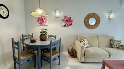 a living room with a table and a couch at Apartamento Flor de Amendoeira Mar in Albufeira