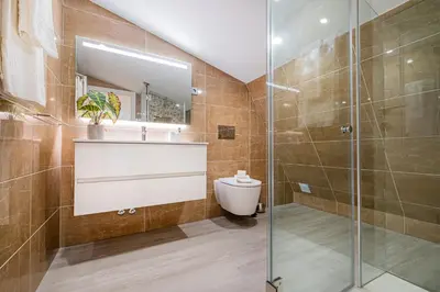 a bathroom with a shower and a sink and a toilet at Old Town Charm Apartment in Albufeira