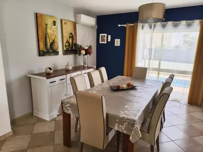 a dining room with a table and chairs at Casa Maré Alta in Guia