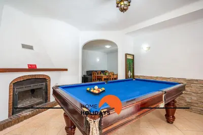 a pool table in a room with a fireplace at #278 Fonte dos Leoes by Home Holidays in Albufeira